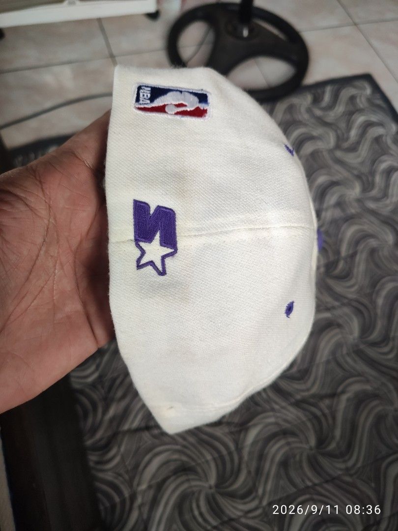 Starter Los Angeles Lakers NBA Snapback Cap (Category: Caps & Hats) located in Las Pinas. Submitted by vtg_sakalam2021 (Listing ID 1460956254, Image 3). Description: - Starter snapback cap for the Los Angeles Lakers. - Classic white with purple brim and details. - Features iconic Lakers logo on the front. - NBA and Starter logos also present on sides and inside. - Adjustable snapback closure for a custom fit. - Size: 7 1/8 - 7 3/8..