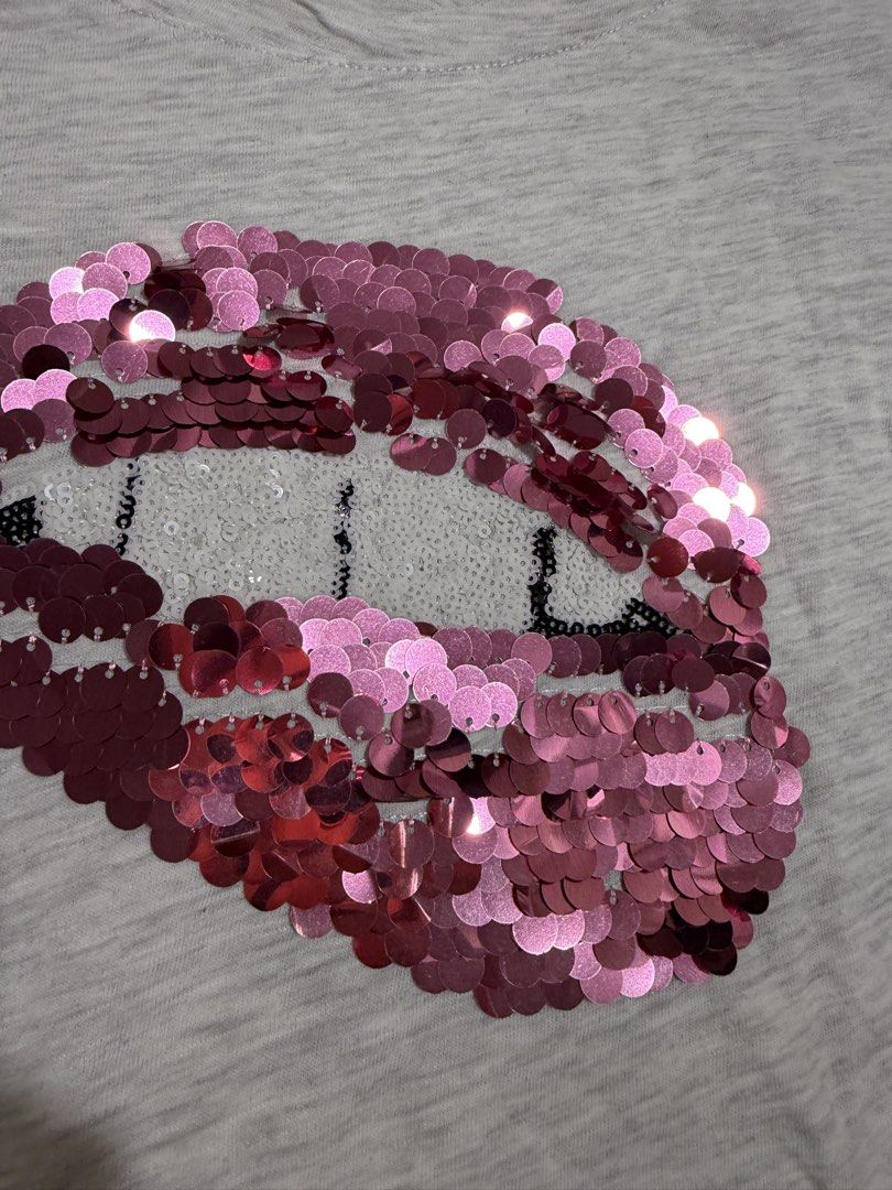 Stradivarius Grey T-shirt with Pink Sequin Lips (Category: Shirts) located in Mandaluyong City. Submitted by kqloset (Listing ID 1461007439, Image 2). Description: - Brand: Stradivarius - Color: Grey - Design: Pink sequin lips on front - Sleeves: Short sleeves - Style: Casual, playful - Pair with: Jeans or shorts.