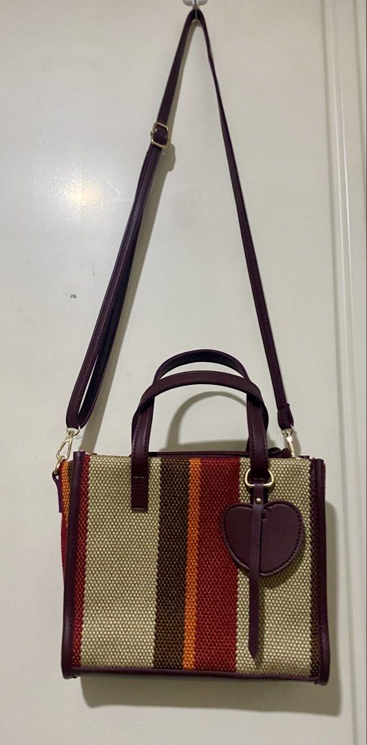 Striped Canvas 2-Way Bag with Heart Charm (Category: Tote Bags) located in Pasig City. Submitted by nakamuraka (Listing ID 1461052841, Image 3). Description: - Cute striped canvas 2-way bag - Detachable crossbody strap included - Small heart charm detail - Interior: 1 zippered pocket, 2 slip pockets .