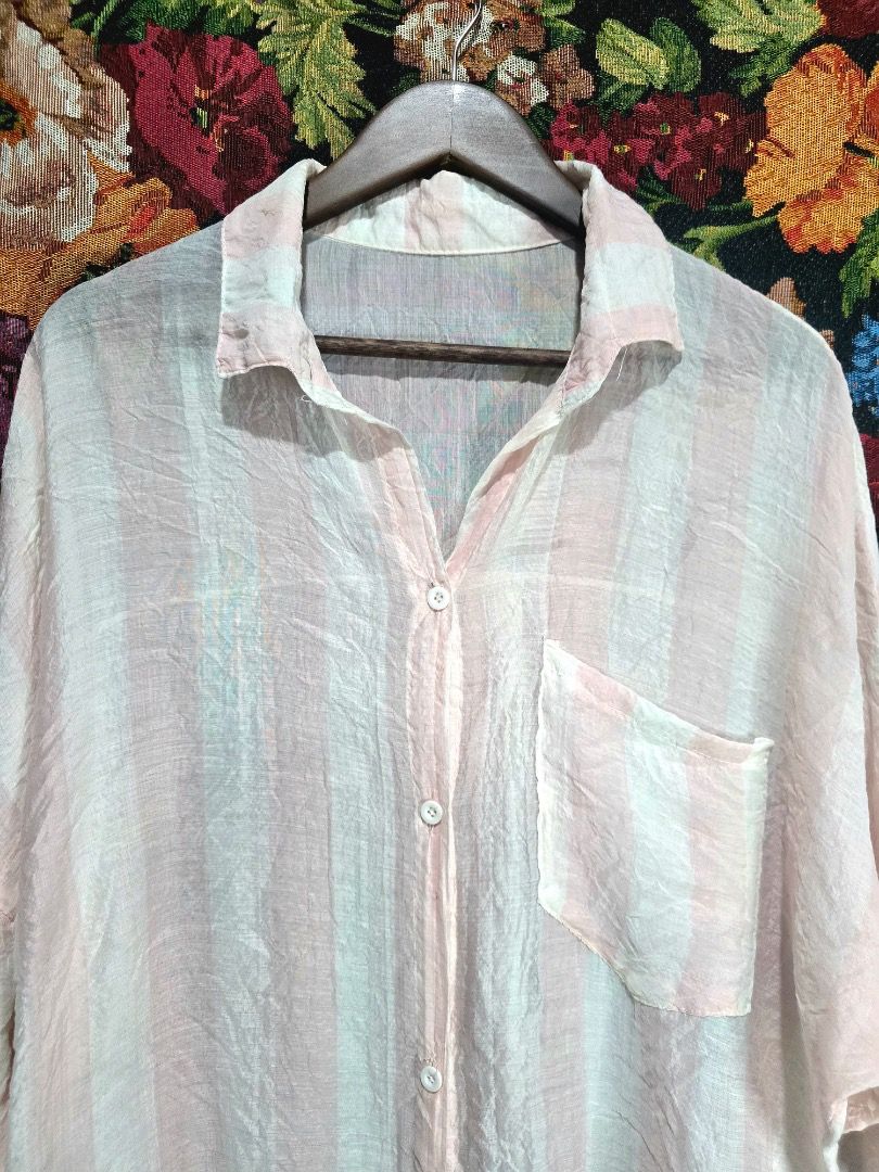 Striped Oversized Shirt (Category: Shirts) located in Paranaque City. Submitted by titaartestudio (Listing ID 1461098911, Image 2). Description: - Lightweight fabric - Pink and white vertical stripes - Single chest pocket - Button-up front - Relaxed, oversized fit - Crinkled texture - Ideal for casual wear or layering.