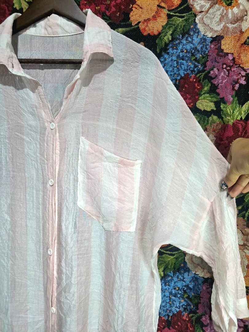 Striped Oversized Shirt (Category: Shirts) located in Paranaque City. Submitted by titaartestudio (Listing ID 1461098911, Image 3). Description: - Lightweight fabric - Pink and white vertical stripes - Single chest pocket - Button-up front - Relaxed, oversized fit - Crinkled texture - Ideal for casual wear or layering.