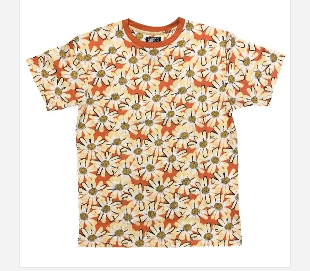 SUPER MASSIVE Daisy Print T-Shirt Orange (Category: Shirts) located in Tarlac. Submitted by momma02 (Listing ID 1460929547, Image 1). Description: - Fun orange t-shirt with an all-over daisy print. - Features white and yellow flowers with black outlines. - Classic crew neck style. - Perfect for a casual, retro vibe. - Approximate measurements: 18 inches pit to pit..