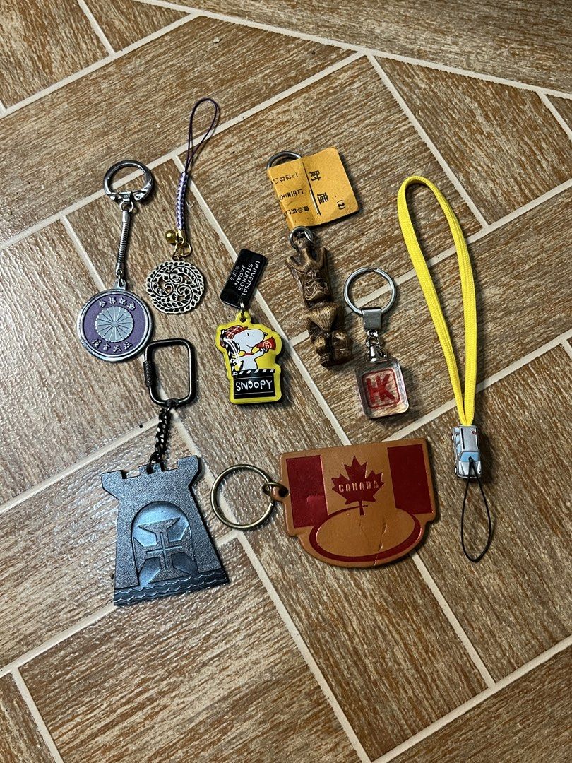 Take All Assorted Keychains: Snoopy, Canada, Japan, Universal Studios (Category: Character Goods) located in Gapan. Submitted by lunashop14 (Listing ID 1461086177, Image 1). Description: - Bundle of assorted keychains - Features a Snoopy keychain from Universal Studios Japan - Includes a Canada maple leaf keychain - Comes with a Japan-themed keychain - Also includes a castle-shaped keychain - A circular keychain with intricate designs is part of 