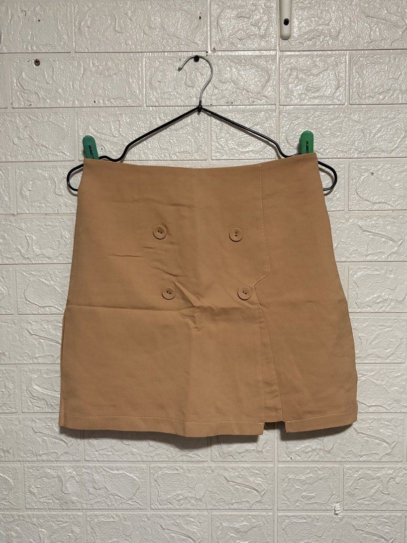 Tan Double Buttoned A-line Skirt with Slit (Category: Skirts) located in Manila. Submitted by _noname.shop (Listing ID 1461055970, Image 1). Description: - Tan A-line skirt - Double button detail on the front - Small slit on the side - Versatile for casual or dressy occasions.