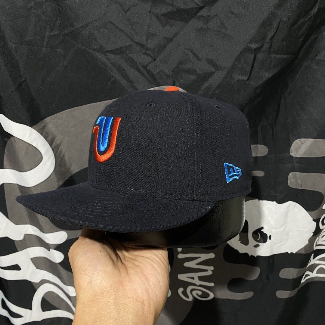 The Clink Room New Era Fitted Cap (Category: Caps & Hats) located in Villasis. Submitted by thriftngrind (Listing ID 1461059836, Image 2). Description: - Brand: New Era X The Clink Room - Model: 59FIFTY Fitted Cap - Color: Navy Blue - Size: 7 1/4 - Side Logo: Small embroidered New Era logo - Top Button: Orange - Limited Edition - Dark Blue colorway.