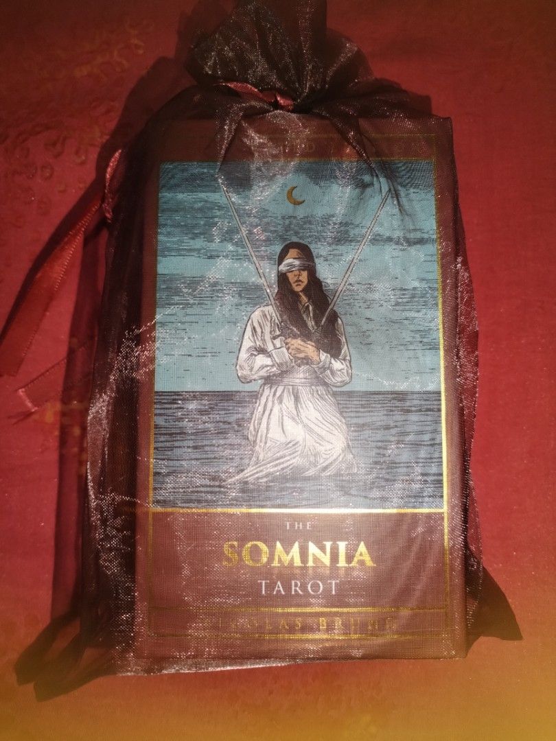 The Somnia Tarot Deck Authentic (Category: Vintage Collectibles) located in Manila. Submitted by archtypeenthusiast (Listing ID 1461001576, Image 1). Description: - Somnia Tarot deck - Comes with a sheer black drawstring bag - Unique box art: blindfolded figure with two swords under a crescent moon - Ideal for tarot collectors - Great for those interested in divination - A unique addition to any tarot collection.