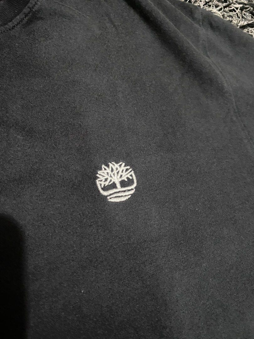 Timberland Black T-Shirt with Logo (Category: Tshirts & Polo Shirts ) located in Baguio. Submitted by arenzu (Listing ID 1461074099, Image 2). Description: - Classic black Timberland t-shirt - Iconic embroidered tree logo on chest - Subtle orange and grey detail on inner neckline - Small orange Timberland tag on the side - Ideal for casual everyday wear.
