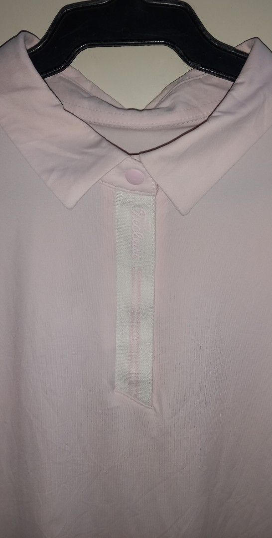 Titleist Pink Golf Shirt Size L (Category: Golf) located in Cagayan de Oro. Submitted by edwardryan01984 (Listing ID 1461048973, Image 2). Description: - Light pink Titleist golf shirt - Short sleeves with collared neckline and button placket - Made from a comfortable and flexible polyester/spandex blend - Ideal for golf or casual wear - Size: Large (L).