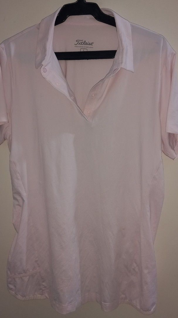 Titleist Pink Golf Shirt Size L (Category: Golf) located in Cagayan de Oro. Submitted by edwardryan01984 (Listing ID 1461048973, Image 3). Description: - Light pink Titleist golf shirt - Short sleeves with collared neckline and button placket - Made from a comfortable and flexible polyester/spandex blend - Ideal for golf or casual wear - Size: Large (L).