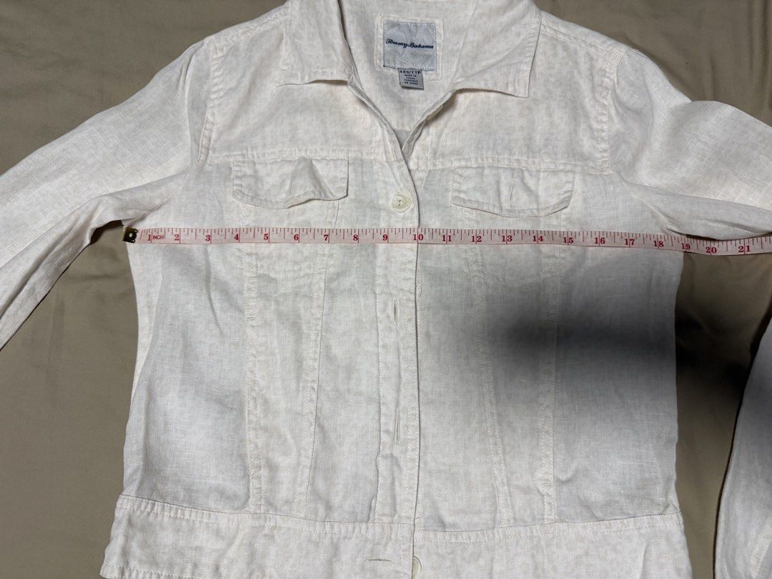 Tommy Bahama Linen Button-Up Jacket XXS/TTP (Category: Coats, Jackets and Outerwear) located in San Jose del Monte. Submitted by thriftream (Listing ID 1460992864, Image 3). Description: - White Tommy Hilfiger jacket - Made from a comfortable linen blend - Features a button-up front - Two chest pockets for convenience - Long sleeves with button cuffs - Ideal for layering over outfits - A versatile addition to any wardrobe.