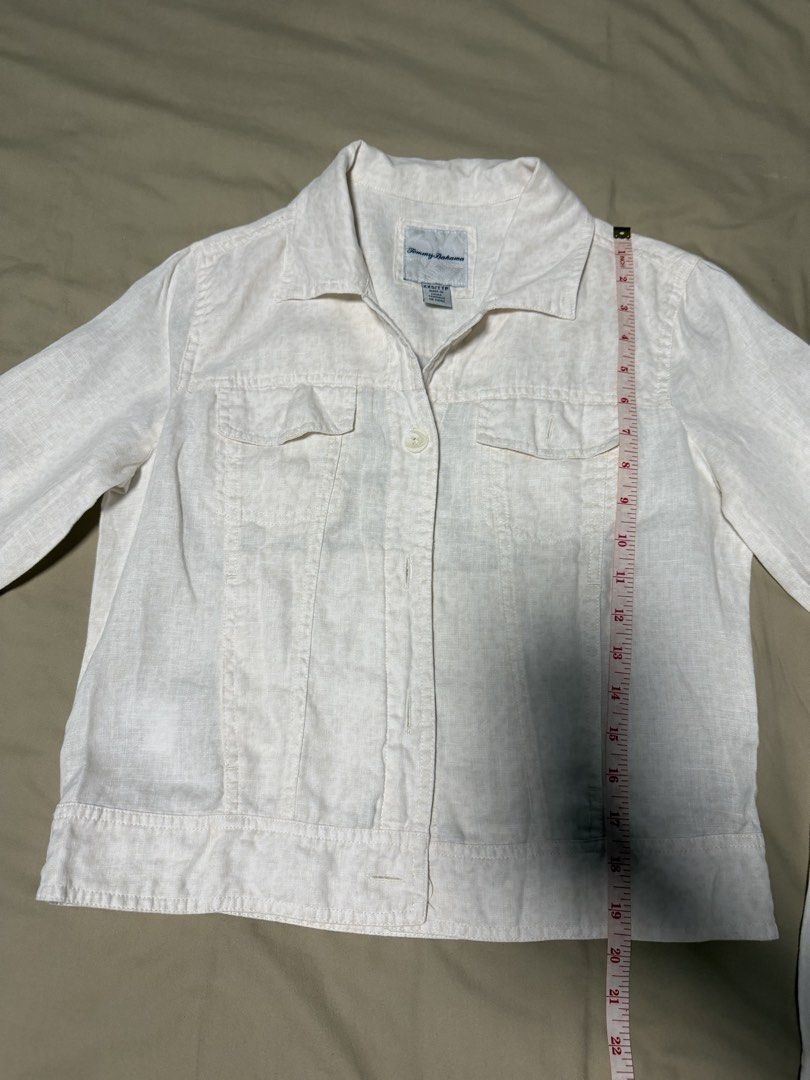 Tommy Bahama Linen Button-Up Jacket XXS/TTP (Category: Coats, Jackets and Outerwear) located in San Jose del Monte. Submitted by thriftream (Listing ID 1460992864, Image 2). Description: - White Tommy Hilfiger jacket - Made from a comfortable linen blend - Features a button-up front - Two chest pockets for convenience - Long sleeves with button cuffs - Ideal for layering over outfits - A versatile addition to any wardrobe.