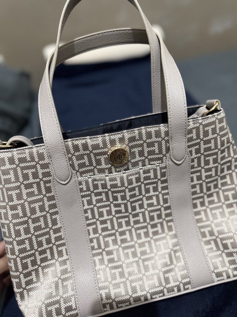 Tommy Hilfiger Monogram Tote Bag (Category: Tote Bags) located in Batangas. Submitted by cathevans (Listing ID 1460977605, Image 1). Description: - Authentic Tommy Hilfiger tote bag - Signature monogram pattern - Light grey trim and handles - Interior zippered compartment and slip pockets - Gold hardware detail on the front - Comes with a detachable shoulder strap - Ideal for everyday use.