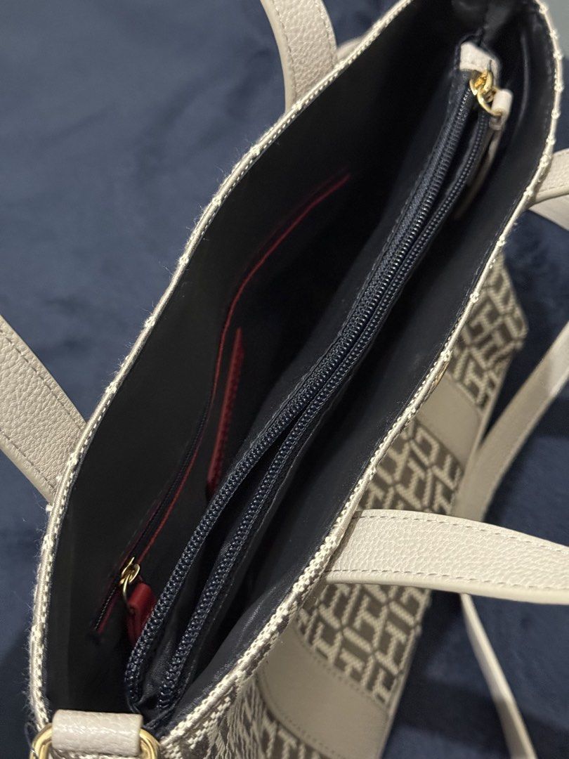 Tommy Hilfiger Monogram Tote Bag (Category: Tote Bags) located in Batangas. Submitted by cathevans (Listing ID 1460977605, Image 2). Description: - Authentic Tommy Hilfiger tote bag - Signature monogram pattern - Light grey trim and handles - Interior zippered compartment and slip pockets - Gold hardware detail on the front - Comes with a detachable shoulder strap - Ideal for everyday use.