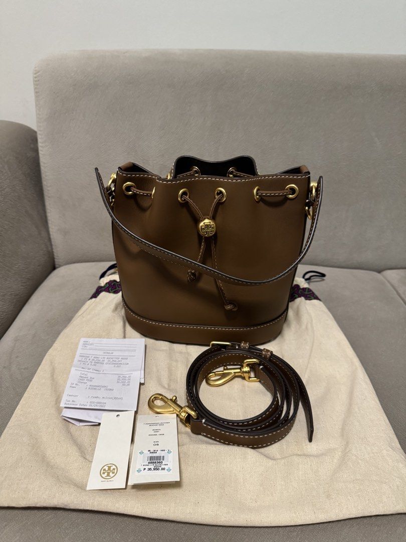 Tory Burch Brown Leather Bucket Bag (Category: Luxury Bags & Wallets) located in Taguig. Submitted by byebyebabies (Listing ID 1461037365, Image 1). Description: - Authentic Tory Burch bucket bag - Color: Brown leather - Detachable strap included - Comes with original dust bag - Original tags and receipt available - Features stylish contrasting stitching - Ideal for everyday wear.