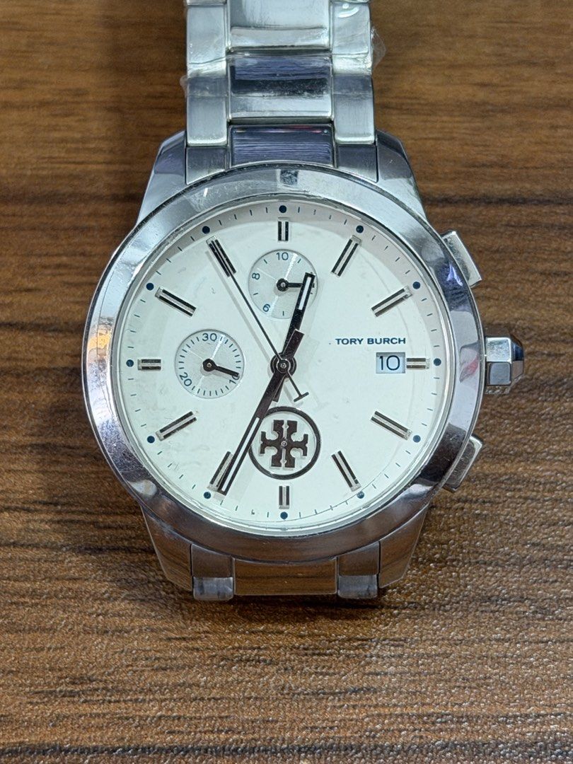 Tory Burch Collins Chronograph Watch ( NEGOTIABLE ) (Category: Women's Watches) located in Laoag. Submitted by wc0414 (Listing ID 1460961111, Image 1). Description: ( NEGOTIABLE ) Brand new, unused. Authentic Tory Burch Collins design. 38mm stainless steel case. Silver stainless steel bracelet with butterfly clasp. Ivory/white dial. Quartz movement. Chronograph function + date display. 3 ATM water resistance. Clean, classy everyday watch. Easy to
