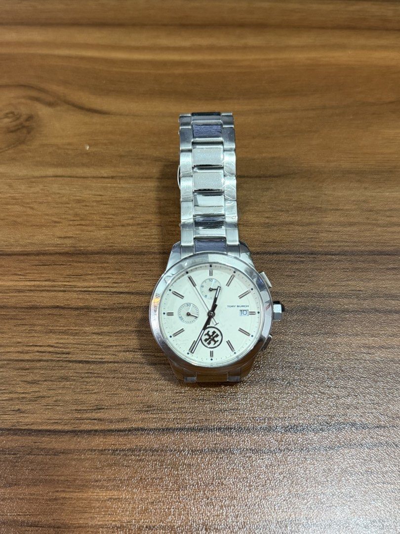 Tory Burch Collins Chronograph Watch ( NEGOTIABLE ) (Category: Women's Watches) located in Laoag. Submitted by wc0414 (Listing ID 1460961111, Image 2). Description: ( NEGOTIABLE ) Brand new, unused. Authentic Tory Burch Collins design. 38mm stainless steel case. Silver stainless steel bracelet with butterfly clasp. Ivory/white dial. Quartz movement. Chronograph function + date display. 3 ATM water resistance. Clean, classy everyday watch. Easy to