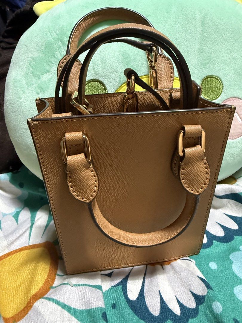 Tory burch mini tote bag (Category: Cross-body Bags) located in Quezon City. Submitted by kashbags (Listing ID 1460969335, Image 2). Description: Original Tory Burch Mini Tote Bag 🤎✨ Condition: Like New / Excellent Condition Color: Beige / Taupe Style: Elegant & classy mini tote Includes: Detachable sling strap — can be worn as a handbag or crossbody 👜 ✔️ Structured and stylish ✔️ Gold-tone hardware ✔️ Perfect for everyday use or special occasi