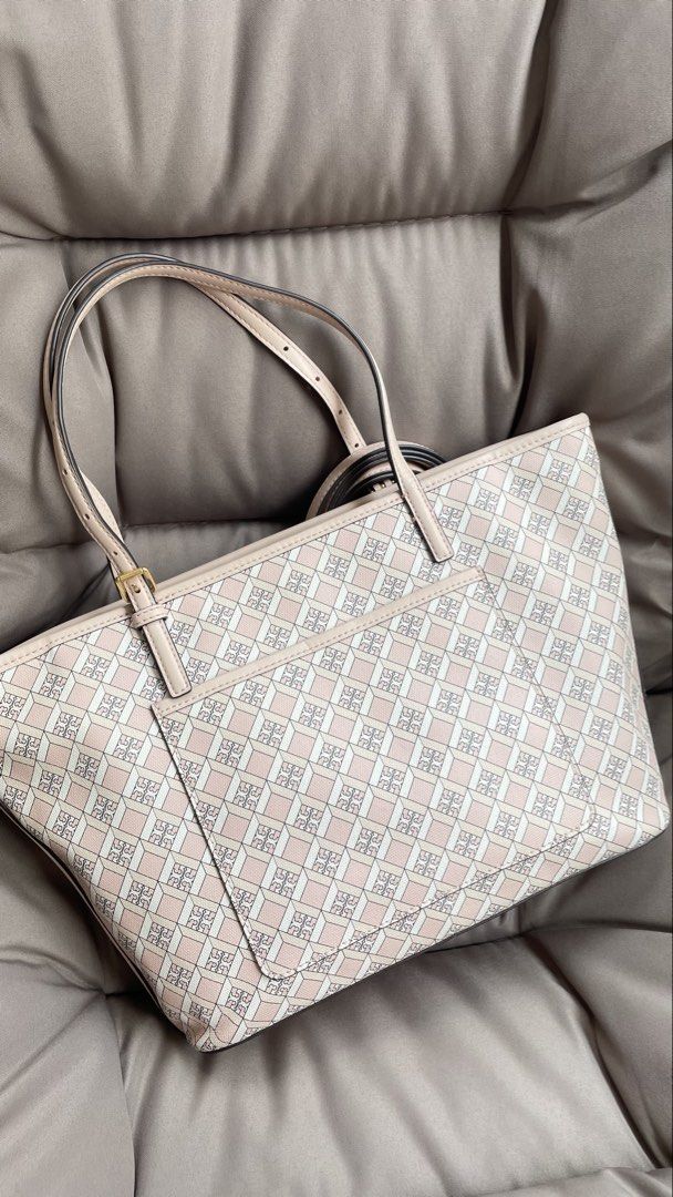Tory Burch Pink Monogram Tote Bag with Strap (Category: Luxury Bags & Wallets) located in Pasig City. Submitted by roseyyylife (Listing ID 1461098873, Image 3). Description: - Pink Tory Burch tote bag - All-over monogram print - Long, adjustable strap included - Elegant gold hardware details - Four protective feet on the bottom - Ample interior space for essentials - Ideal for everyday use or travel.