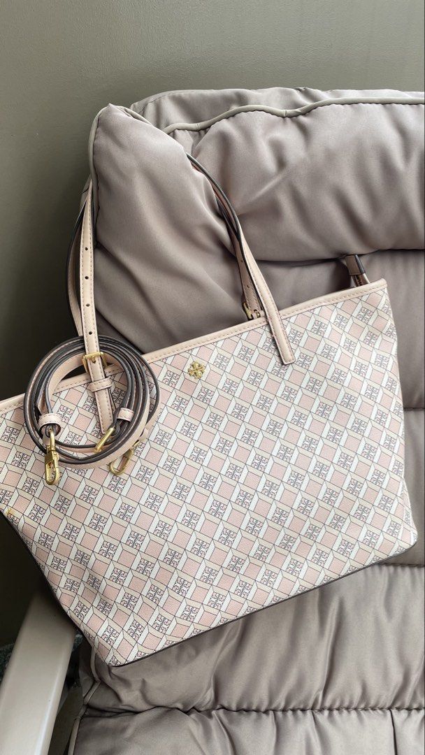 Tory Burch Pink Monogram Tote Bag with Strap (Category: Luxury Bags & Wallets) located in Pasig City. Submitted by roseyyylife (Listing ID 1461098873, Image 1). Description: - Pink Tory Burch tote bag - All-over monogram print - Long, adjustable strap included - Elegant gold hardware details - Four protective feet on the bottom - Ample interior space for essentials - Ideal for everyday use or travel.