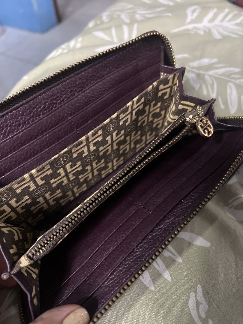 Tory Burch Purple Leather Zip Around Wallet (Category: Wallets & Card holders) located in Lipa City. Submitted by wen_68 (Listing ID 1460991573, Image 3). Description: - Authentic Tory Burch purple leather wallet - Secure zip-around closure - Multiple interior card slots for easy organization - Zippered pocket for coins or small items - Signature Tory Burch logo pattern lining - Ideal for keeping your essentials tidy and accessible.