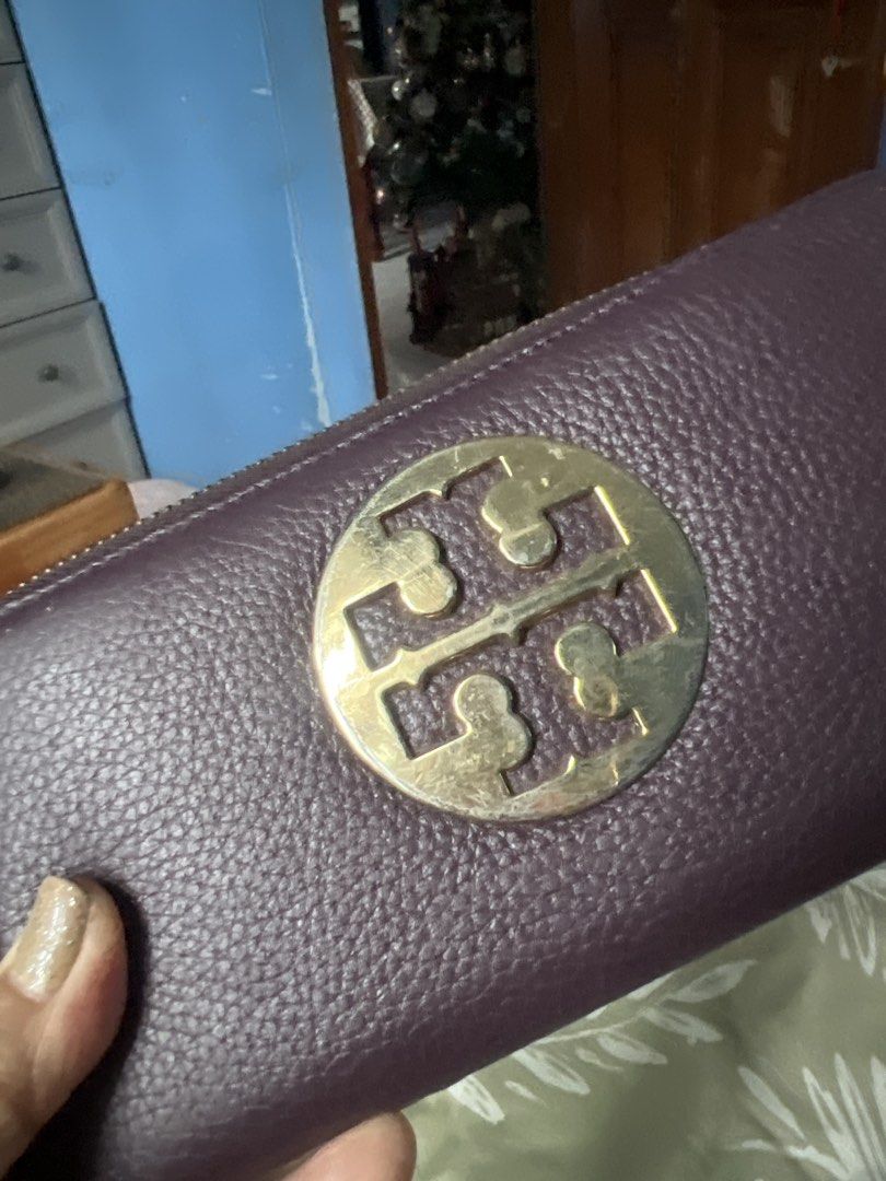 Tory Burch Purple Leather Zip Around Wallet (Category: Wallets & Card holders) located in Lipa City. Submitted by wen_68 (Listing ID 1460991573, Image 2). Description: - Authentic Tory Burch purple leather wallet - Secure zip-around closure - Multiple interior card slots for easy organization - Zippered pocket for coins or small items - Signature Tory Burch logo pattern lining - Ideal for keeping your essentials tidy and accessible.