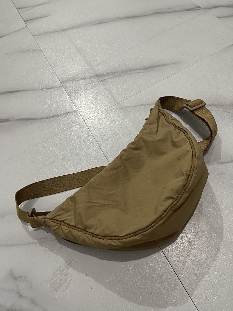 UNIQLO ROUND MINI SHOULDER BAG 'Beige' (Category: Shoulder Bags) located in Quezon City. Submitted by ryanj26 (Listing ID 1460980767, Image 2). Description: Volume : 4 liters Dimes : W - 11inches, H 6.7 inches Shoulder Strap - 45 inches Quality: In excellent condition NO ISSUE..