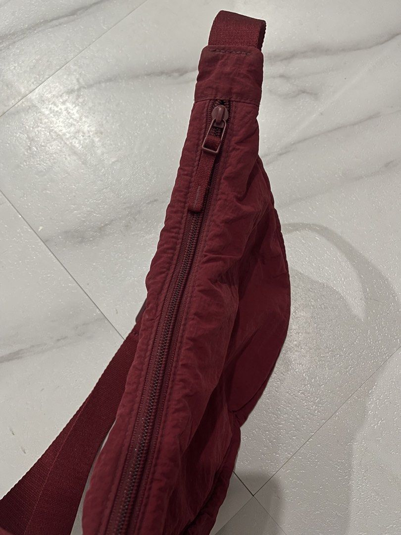 UNIQLO ROUND MINI SHOULDER BAG 'maroon' (Category: Shoulder Bags) located in Quezon City. Submitted by ryanj26 (Listing ID 1460981243, Image 3). Description: Volume : 4 liters Dimes : W - 11inches, H 6.7 inches Shoulder Strap - 45 inches Quality: In excellent condition NO ISSUE..