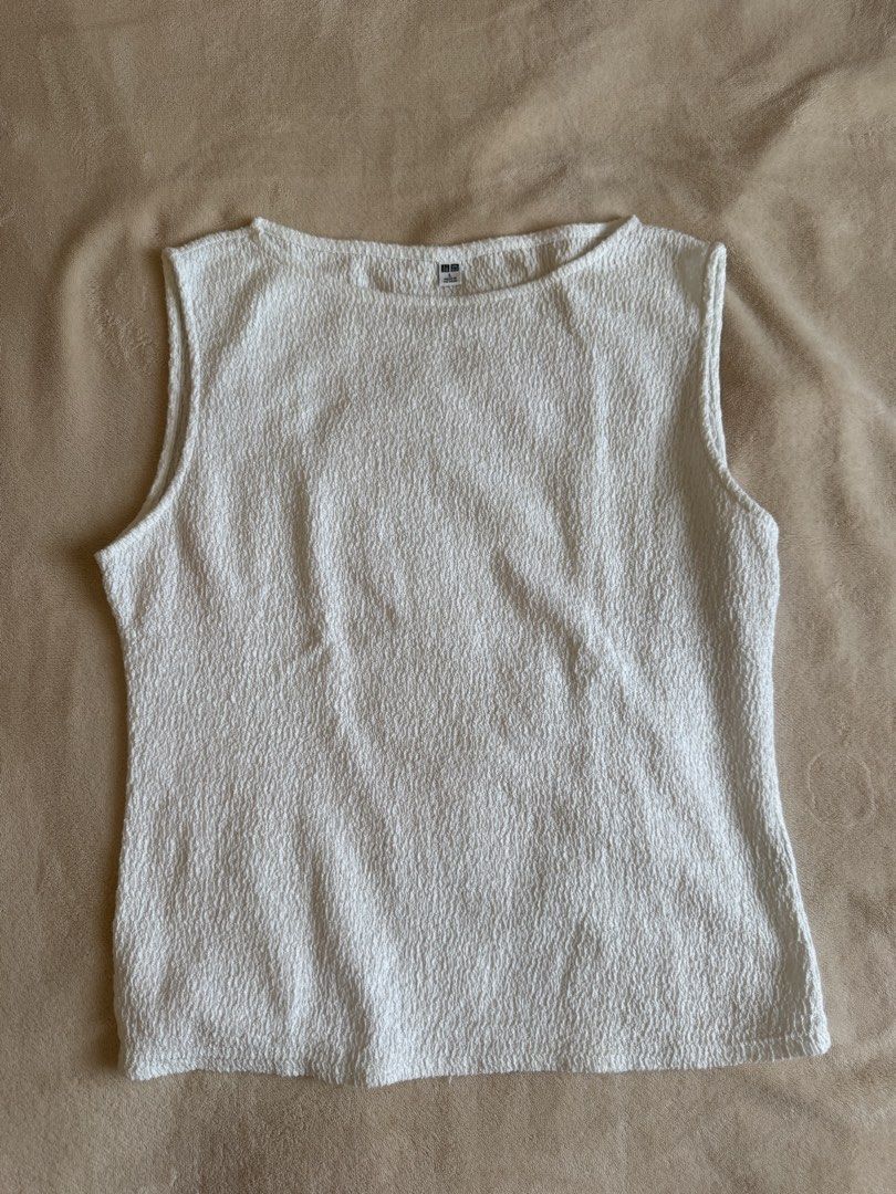 Uniqlo White Textured Sleeveless Top (Category: Sleeveless) located in Bacolod City. Submitted by bellabianca_closet (Listing ID 1461054779, Image 2). Description: Disclaimer: 1st photo not mine - White sleeveless top from Uniqlo - Features a textured fabric all over - Elegant boat neck design - Versatile for layering or wearing solo - Effortlessly pairs with any outfit.