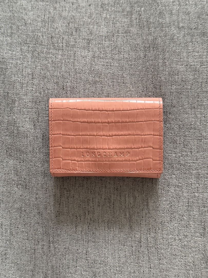 Authentic Ví Longchamp Pocket Compact (Category: Wallets & Card holders) located in Makati City. Submitted by shopmoemoe (Listing ID 1460976199, Image 1). Description: - Authentic Pink Longchamp Wallet - Luxurious Croc Embossed Leather - Secure Snap Closure - Interior: 6 Card Slots & Coin Pouch - Elegant Gold Hardware Details - Compact Size: Fits easily in small bags - Ideal for Everyday Use.