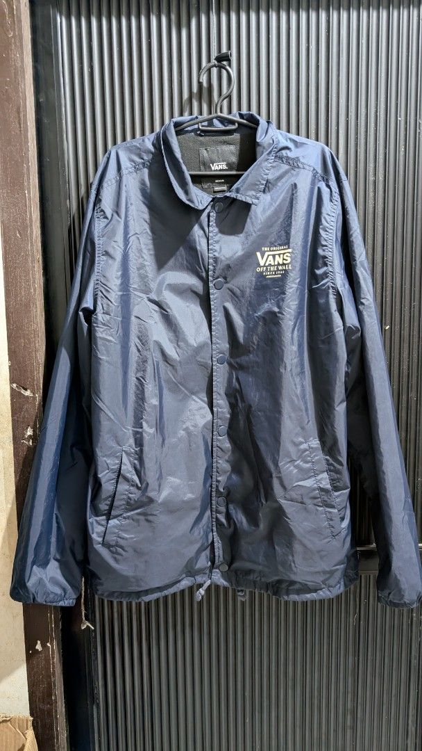 Vans "The Original Off The Wall Since 1966" Coach Jacket (Category: Coats, Jackets and Outerwear) located in Manila. Submitted by bravehawk_bba564 (Listing ID 1460929248, Image 1). Description: - Vans Torrey Coach Jacket Navy Blue - Size: Medium, Dimes: 22W 28L - Made in China - Features: Button-up front, collar, drawstring hem, Vans logo on chest (both), Vans Logo on back (navy blue), soft inner lining Location: Valenzuela City .