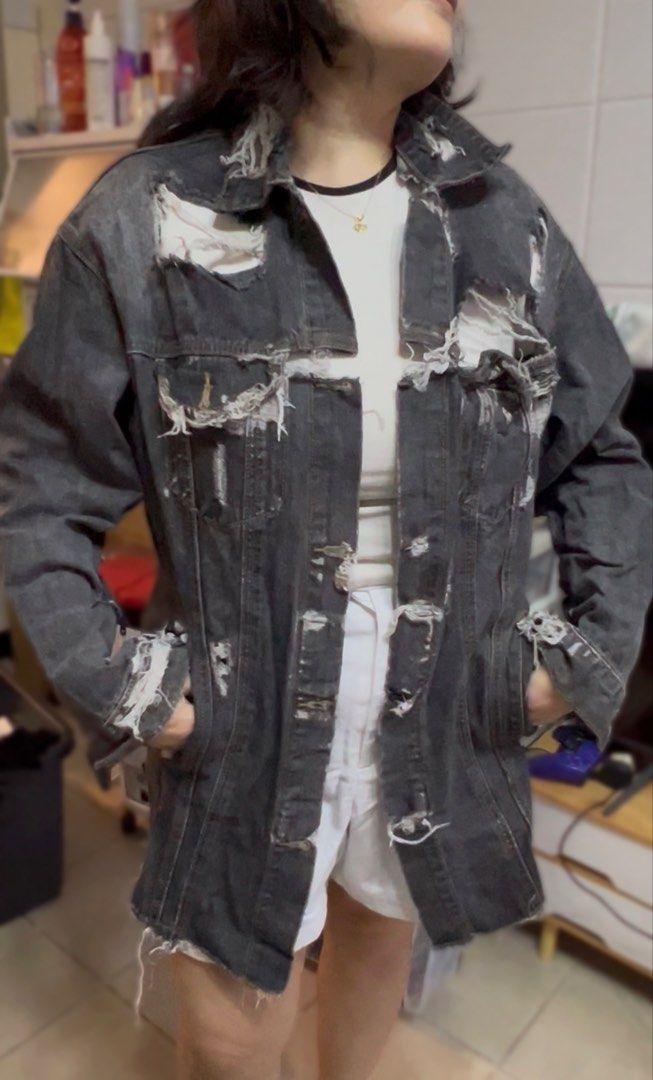 VETEMENTS Distressed Denim Jacket (Category: Coats, Jackets and Outerwear) located in Surigao. Submitted by boonz71_1971 (Listing ID 1461077278, Image 1). Description: Declutter Sale -unisex for men/women - Width 21” Length 27” - Brand: VETEMENTS - Type: Distressed Denim Jacket - Color: Faded Black - Size: Estimated Medium/Large - Features: Rips and tears throughout, button-up front, collar, long sleeves with frayed cuffs - Style: Bold statement 