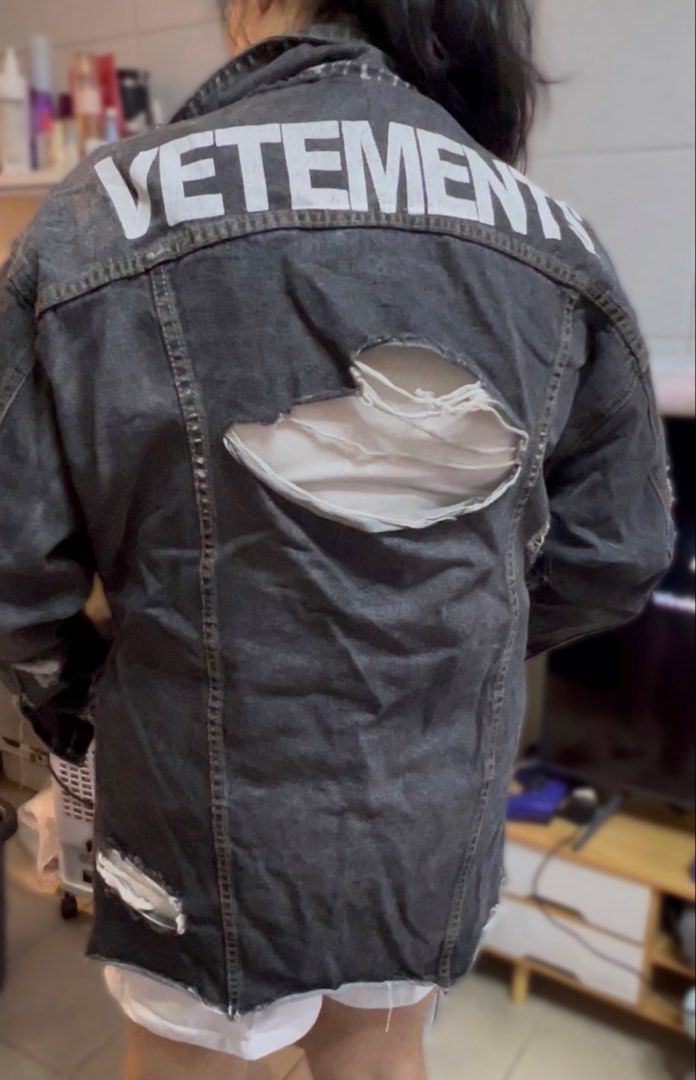 VETEMENTS Distressed Denim Jacket (Category: Coats, Jackets and Outerwear) located in Surigao. Submitted by boonz71_1971 (Listing ID 1461077278, Image 3). Description: Declutter Sale -unisex for men/women - Width 21” Length 27” - Brand: VETEMENTS - Type: Distressed Denim Jacket - Color: Faded Black - Size: Estimated Medium/Large - Features: Rips and tears throughout, button-up front, collar, long sleeves with frayed cuffs - Style: Bold statement 