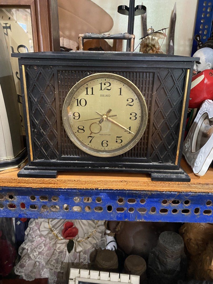 Vintage Seiko Transistor Desk Clock Japan (Category: Clocks) located in Manila. Submitted by worldwidep31372 (Listing ID 1460929494, Image 1). Description: - Vintage Seiko transistor desk clock - Made in Japan - Gold face with black numbers and hands - Black casing with gold trim - Features a convenient top handle - Battery compartment located at the back - Sold as is.