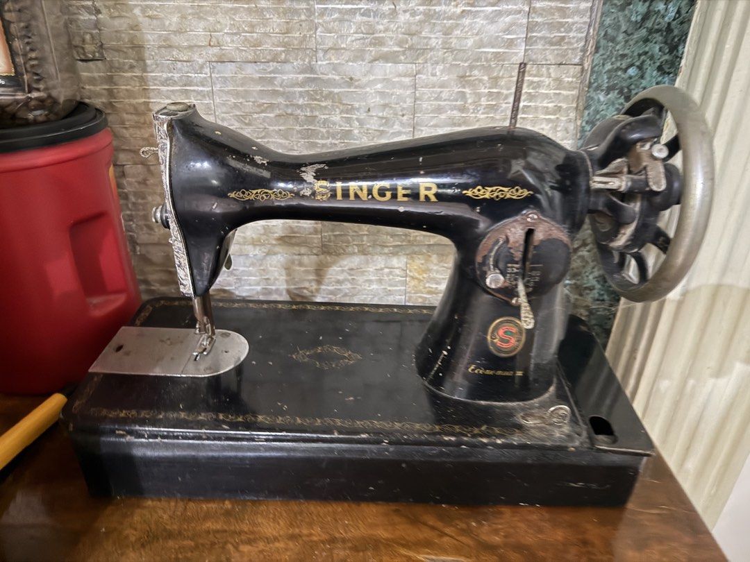 Vintage Singer Sewing Machine (Category: Craft Supplies & Tools) located in Manila. Submitted by wildcloud_82aace (Listing ID 1460973080, Image 2). Description: - Classic black Singer sewing machine - Features iconic gold Singer logo - Mechanical, manual operation via handwheel - Black base with decorative gold trim - Ideal for collectors or decorative display.