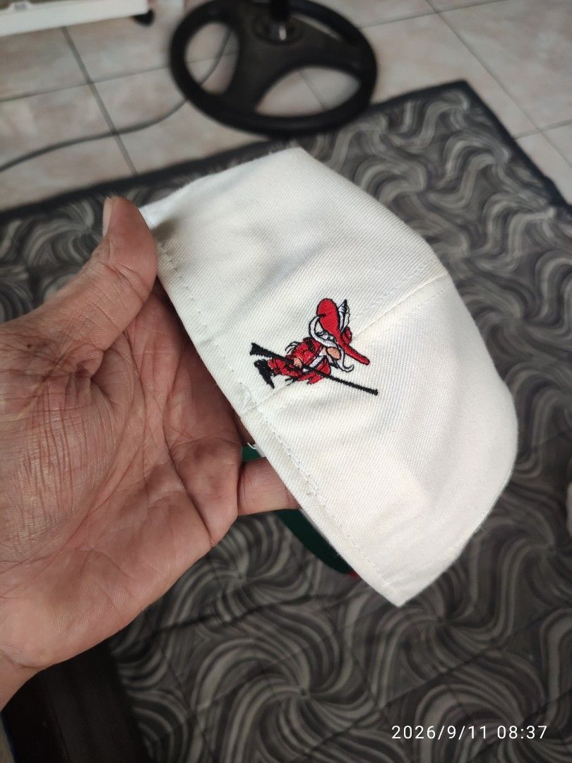 Vintage UNLV Rebels Snapback Cap Red White Green (Category: Caps & Hats) located in Las Pinas. Submitted by vtg_sakalam2021 (Listing ID 1460956000, Image 2). Description: - Classic UNLV Rebels snapback hat - White front with bold red lettering - Red brim with a cool green underbrim - Features a unique embroidered cartoon character on the side - Perfect for any UNLV fan! - fitted hat 7 1/2.
