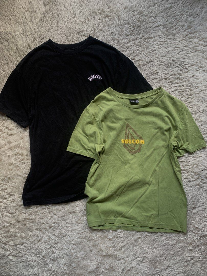 Volcom T-Shirts Bundle (Black & Green) (Category: Tshirts & Polo Shirts ) located in General Santos City (Dadiangas). Submitted by thrifty_gsc (Listing ID 1461022187, Image 2). Description: - Two Volcom graphic tees for sale. - Black tee: Features classic Volcom Stone logo and '19 91' graphic. - Green tee: Showcases a skull graphic on the front and text on the back. - Both are short-sleeved. - Ideal for everyday casual wear..