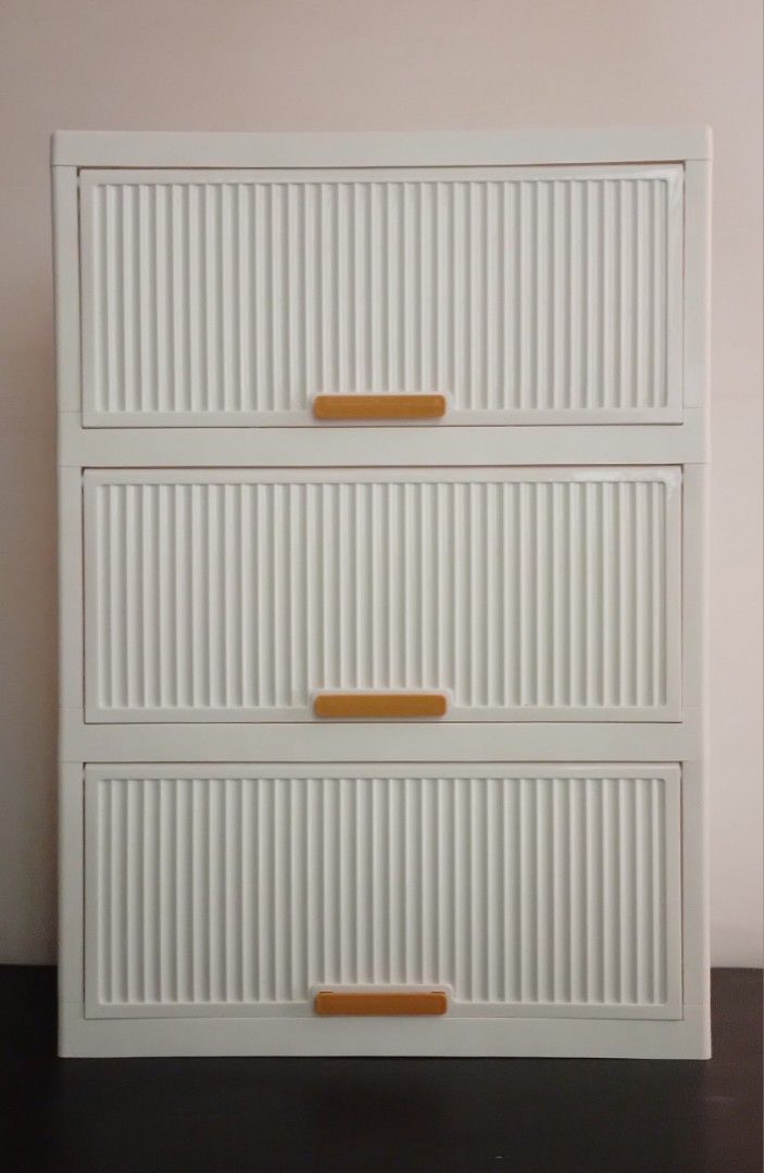 White 3-Tier Storage Cabinet (Category: Shelves, Cabinets & Racks) located in Pasig City. Submitted by kuhkuh (Listing ID 1460955358, Image 1). Description: White storage cabinet (3-tier) Short-time used (used as display rack only) 💕Bought in Shopé Php 812. 🎈Now sells @ 700. - Features a ribbed design on the drawer fronts - Equipped with stylish wooden-like handles - Ideal for organizing clothes, toys, or general household items - Smooth and ea