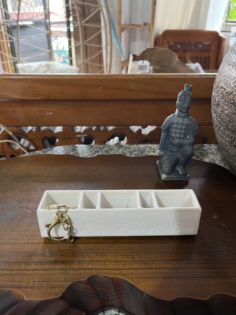 White Ceramic 5-Compartment Trinket Dish Organizer (Category: Other Home Decor) located in Taguig. Submitted by minmin_parker (Listing ID 1461003506, Image 1). Description: - White ceramic dish with 5 compartments - Perfect for organizing small items like rings, earrings, or keys - Features a textured finish - Measures approximately 6 inches long - Adds a stylish touch to your dresser or entryway table.