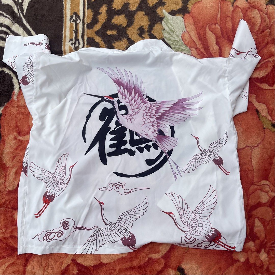 White Crane Print Kimono Jacket (Category: Coats, Jackets and Outerwear) located in Manila. Submitted by aikyy_ (Listing ID 1460923467, Image 2). Description: - White kimono jacket - Features a striking crane and cloud print - Large crane graphic on the back with Japanese calligraphy - Tag reads 'STAND BACK' - Minor stains on the front, visible in the last two photos (washable) - Ideal for stylish layering over any outfit.
