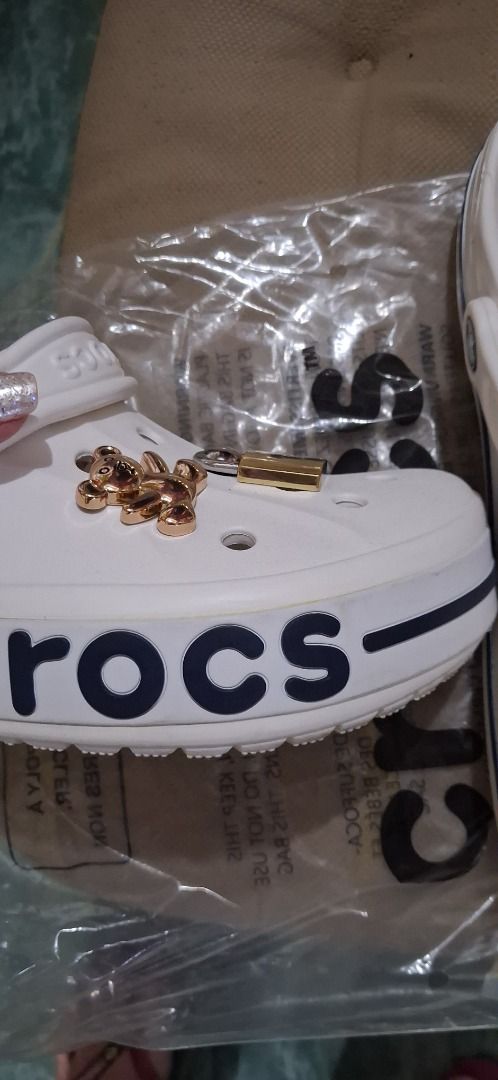 White Crocs with Teddy Bear, Lock, and Heart Charms (Category: Charms) located in Manila. Submitted by katkween23 (Listing ID 1460961692, Image 2). Description: - White Crocs - Decorated with cute charms: teddy bear, lock, and rhinestone heart - Easy to slip on and off - Perfect for casual wear and personal style.