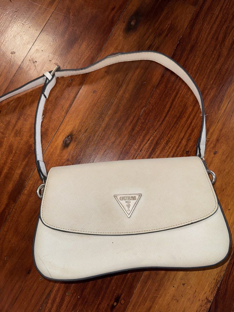 White Guess Shoulder Bag (Category: Shoulder Bags) located in Angeles City. Submitted by inahaldrienne (Listing ID 1460988950, Image 1). Description: - White Guess shoulder bag - Flap closure with magnetic snap - Interior zippered compartment and slip pockets - Minor marks on exterior and interior lining - Adjustable strap - Ideal size for everyday essentials.