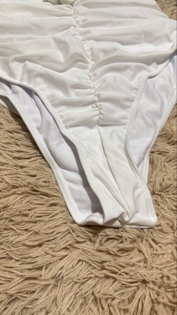 White Halterneck Ruched Swimsuit (Category: Bikinis & Swimsuits) located in Quezon City. Submitted by dearpretty.ph (Listing ID 1461047000, Image 3). Description: Small-Medium size M on tag Camera used: iPhone 15 Pro Max Colors may slightly vary due to lighting.