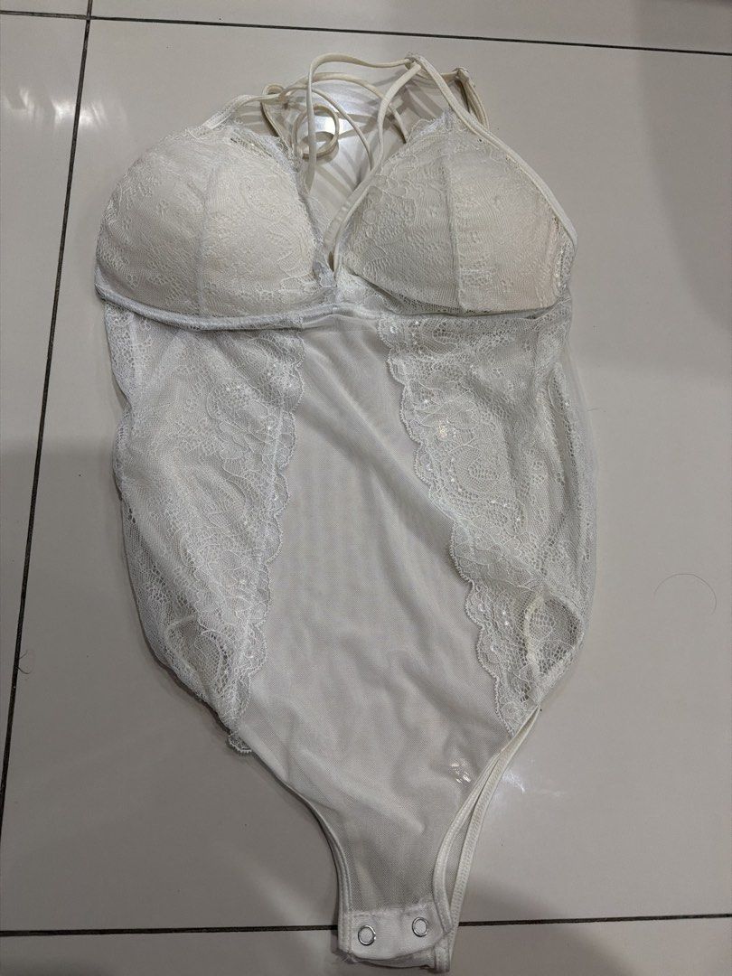 White Lace Bodysuit with Strappy Back (Category: Others Tops) located in Rizal. Submitted by macristina33105 (Listing ID 1461025262, Image 1). Description: - White lace bodysuit - Strappy detail on the back - Padded cups for support - Snap closure at the bottom - Estimated size: Medium - Versatile: great for layering or wearing on its own.