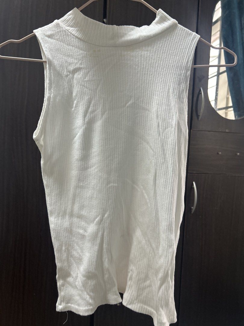 White Ribbed Mock Neck Sleeveless Top (Category: Sleeveless) located in Manila. Submitted by silverhawk.069da5 (Listing ID 1460950451, Image 2). Description: - White ribbed sleeveless top - Mock neck design - Stretchy material for a comfortable fit - Perfect basic for layering or wearing alone - Effortlessly matches with jeans, skirts, and more.