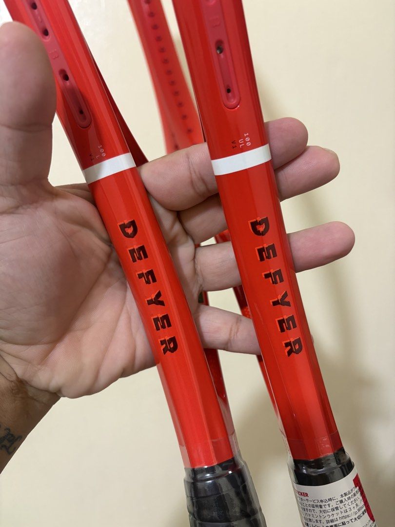 Wilson Defyer Tennis Rackets (2 pcs) (Category: Racket and Ball Sports) located in Manila. Submitted by therealhandsoftime (Listing ID 1461084937, Image 2). Description: - Pair of red Wilson Defyer tennis rackets - Ideal for players looking for a new set - Great value for two rackets -265g, G1 -285g, G2.