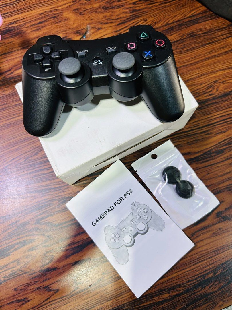 Wireless Gamepad Controller for PS3 (Category: Controllers) located in Manila. Submitted by starbalesukandjapansurplus (Listing ID 1460949624, Image 1). Description: - Black Wireless Controller for PS3 - Tested and confirmed working - Includes original manual - Comes with extra thumb grips - Connects via USB cable - Ideal for extended gaming sessions.