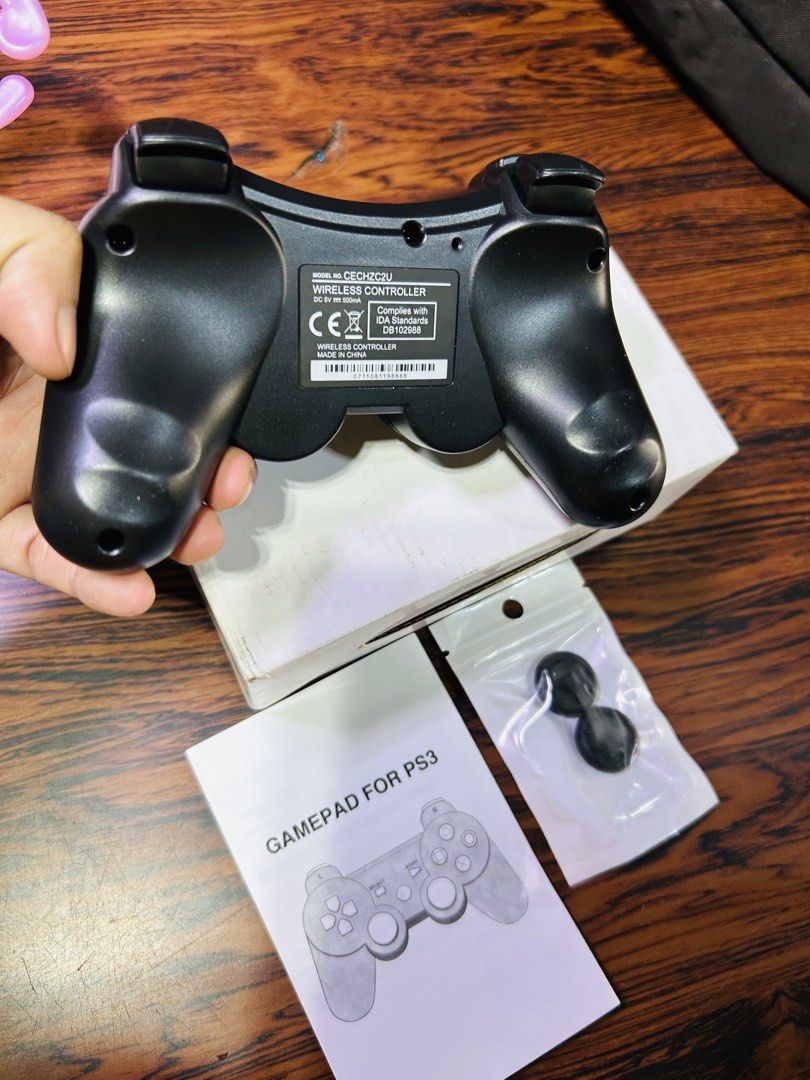 Wireless Gamepad Controller for PS3 (Category: Controllers) located in Manila. Submitted by starbalesukandjapansurplus (Listing ID 1460949624, Image 3). Description: - Black Wireless Controller for PS3 - Tested and confirmed working - Includes original manual - Comes with extra thumb grips - Connects via USB cable - Ideal for extended gaming sessions.