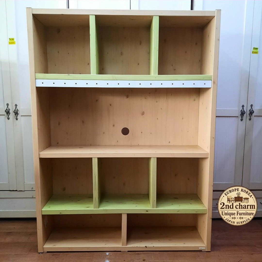 Wooden Combination Bookcase & Entertainment Divider (Category: Shelves, Cabinets & Racks) located in Manila. Submitted by ivan_furnitures421 (Listing ID 1460925753, Image 1). Description: - Light pine wood bookcase with charming pastel green accents. - Versatile use: Ideal for storing books or as a stylish media center divider. - Convenient cable management: Features a pre-drilled hole for cables. - Dimensions: L120cm x W38cm x H161cm. - Price: P