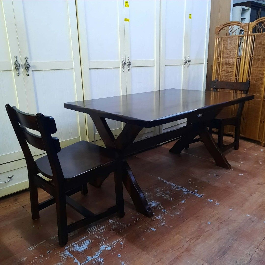 Wooden Dining Table and Chairs Set (Category: Tables & Sets) located in Manila. Submitted by ivan_furnitures421 (Listing ID 1460926089, Image 3). Description: - Dark wood dining table with unique cross-leg design. - Includes 2 chairs with simple, classic backrests. - Ideal for small dining areas or kitchens. - Sturdy and durable construction. - Ready for its new home..