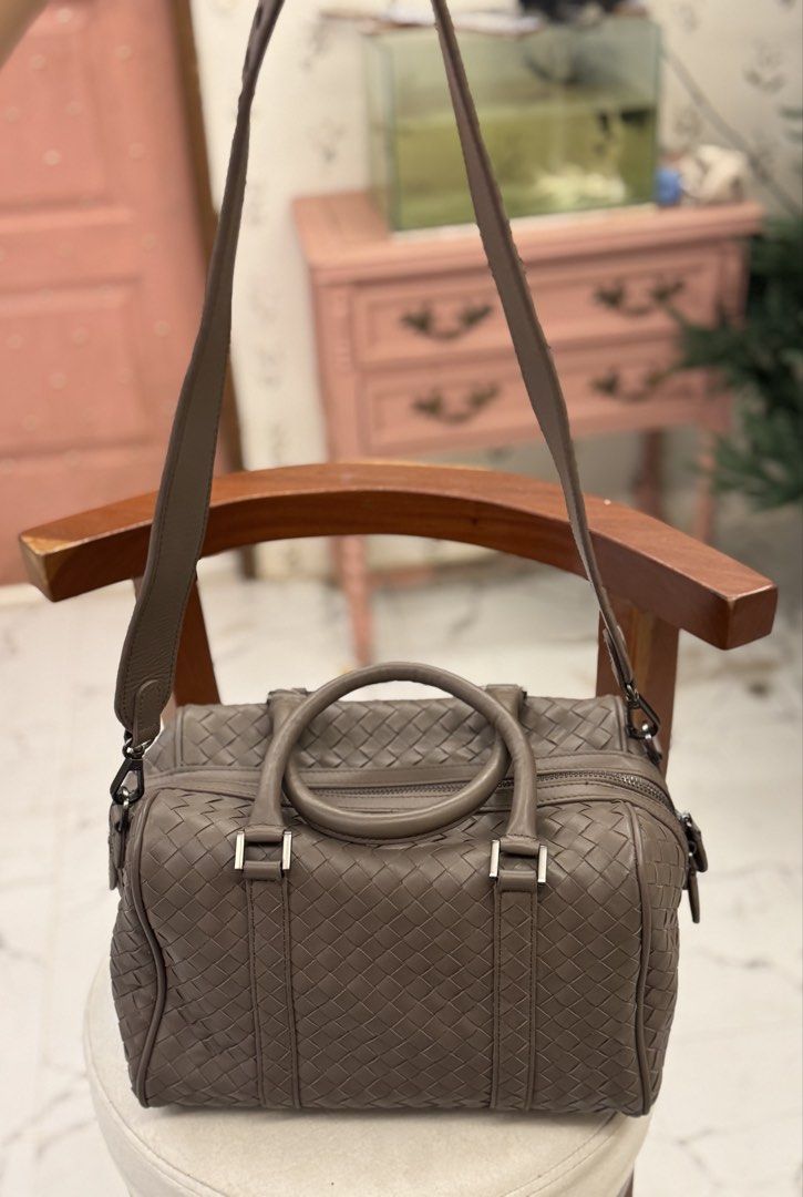 Woven Leather Boston Bag (Category: Luxury Bags & Wallets) located in Bacolod City. Submitted by vintage_vogue6100 (Listing ID 1461000425, Image 2). Description: - Signature intrecciato woven leather - Taupe/grey color - Detachable shoulder strap included - Top zip closure - Two top handles - Ideal size for everyday or travel.